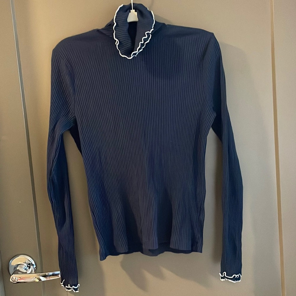 Blue turtleneck with ruffled edge